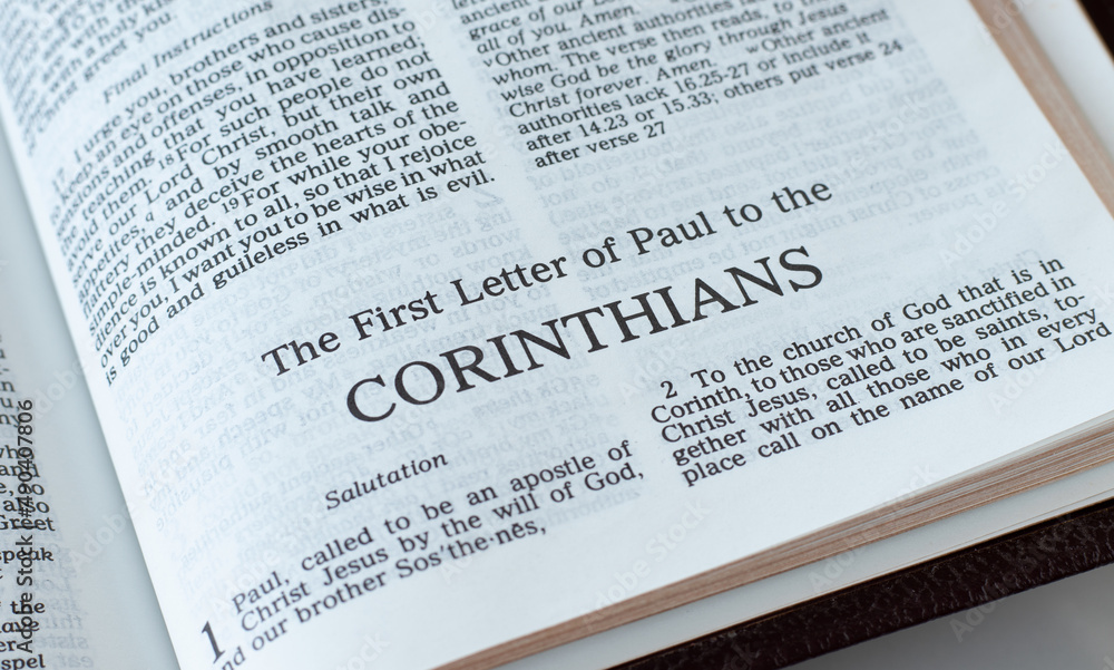Obraz premium Corinthians open Holy Bible Book close-up. New Testament Scripture. Studying the Word of God Jesus Christ. Christian biblical concept of faith and trust. 