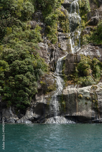 Waterfall in the Rock Face in Milford Sound Fiordland National Park in the South Island of New Zealand on a Sunny Day