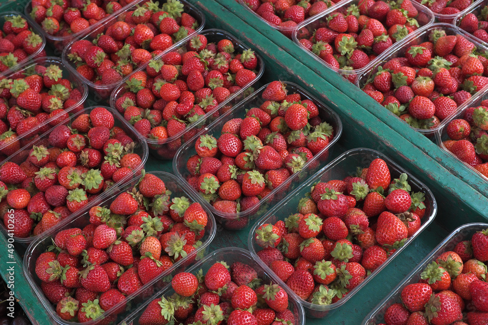 Fresh ripe strawberries in plastic boxes on the market stall ... Fresh ripe strawberries in plastic boxes on the market stall ...