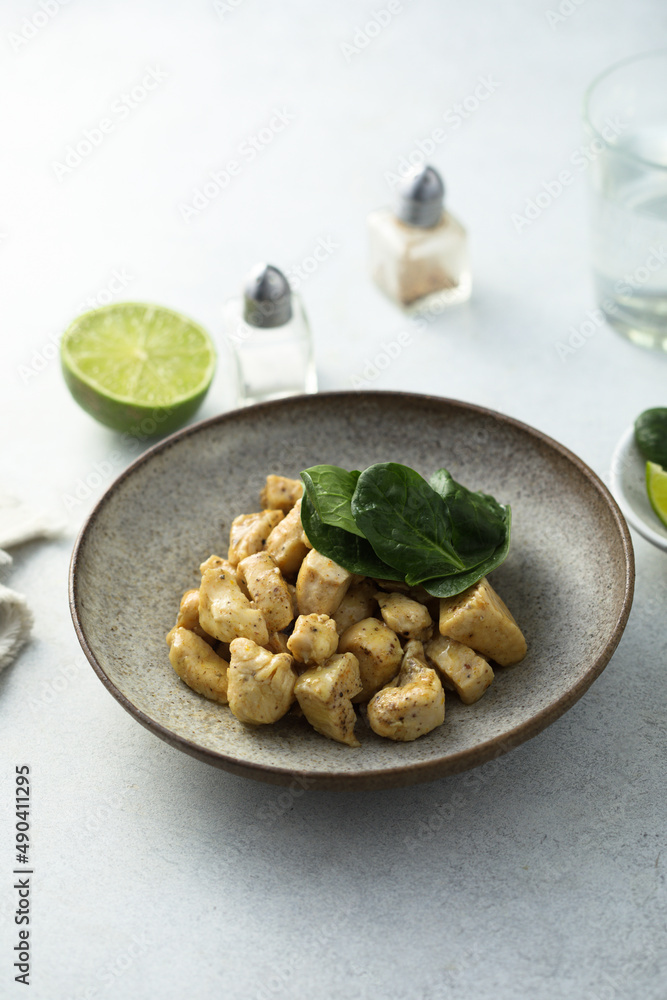 Baked chicken meat with spinach and lime
