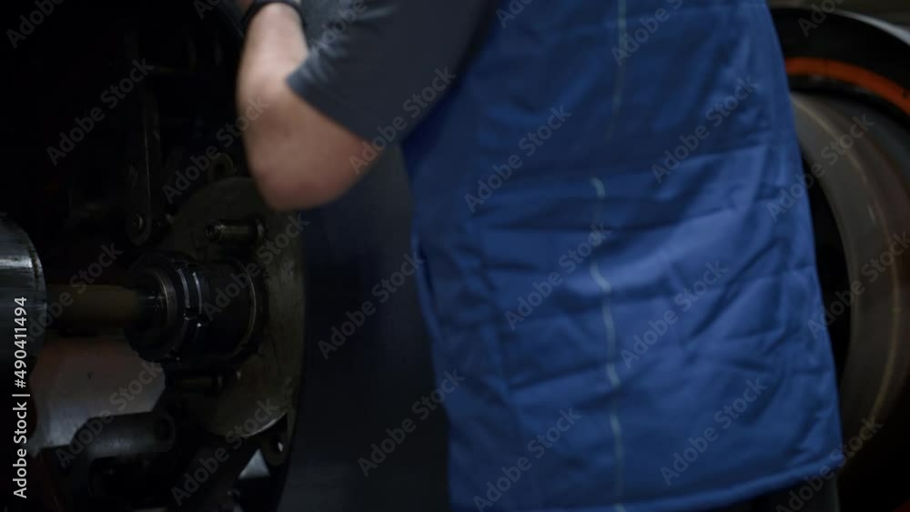 Tyre manufacture employee hands operating rubber tape on technological machine Tyre manufacture employee hands operating rubber tape on technological machine