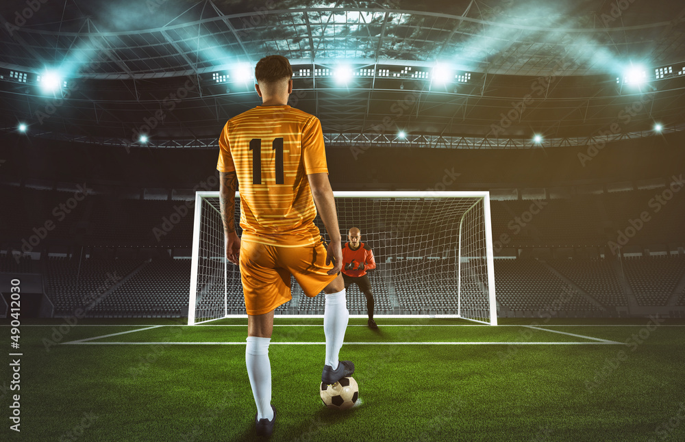Soccer scene at night match with player in yellow uniform kicking the penalty kick - obrazy, fototapety, plakaty 