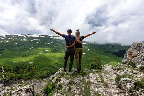 A man with a girl on the background of the alpine meadows of the Lago-Naki plateau in Adygea. Russia. 2021.