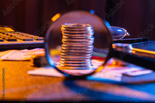 A stack of iron money. View of a small change through a magnifying glass. Pocket money under a magnifying glass.