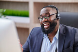 Representive African American practitioner leads online training wearing a suit and headset, active gestures and explanations