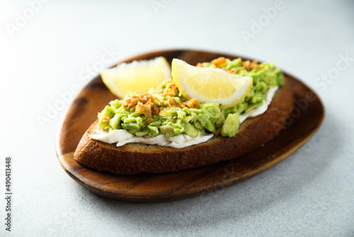 Homemade avocado toast with cream cheese and lemon