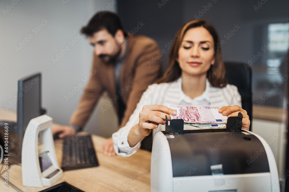 A man and a woman work together in an exchange office. A man and a woman work together in an exchange office.
