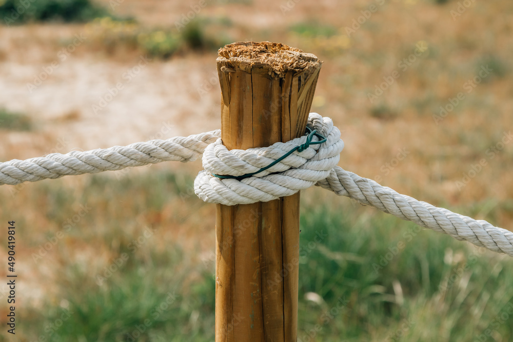 close-up of rope tied to wooden post