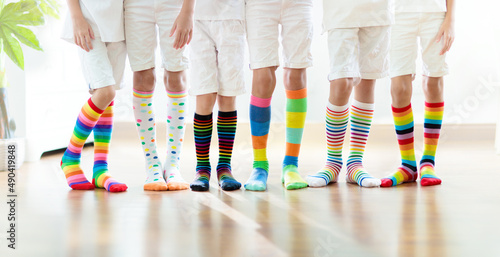 Kids wearing colorful rainbow socks. 
