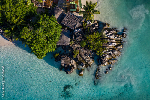 Aerial photo over Seychelles displaying the natural unspoilt beauty of the islands - from the crystal clear oceans to the lush green forests and granite boulders cascading on the white beaches. 