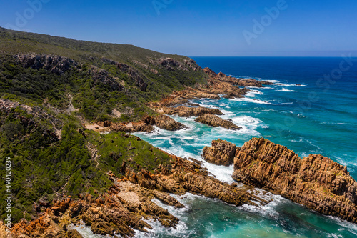 Aerial photo of the rugged coastline of Knysna, Western Cape, South Africa.  Photo taken using a drone over the cliffs, beaches and coastline.