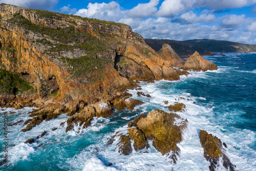 Aerial photo of the rugged coastline of Knysna, Western Cape, South Africa.  Photo taken using a drone over the cliffs, beaches and coastline.
