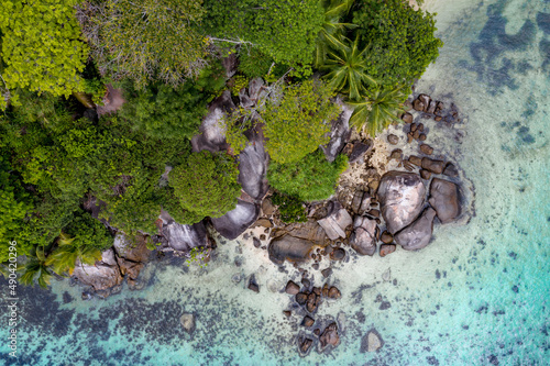 Aerial photo over Seychelles displaying the natural unspoilt beauty of the islands - from the crystal clear oceans to the lush green forests and granite boulders cascading on the white beaches. 