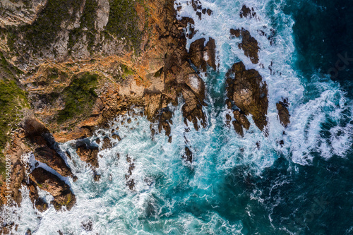 Aerial photo of the rugged coastline of Knysna, Western Cape, South Africa.  Photo taken using a drone over the cliffs, beaches and coastline.