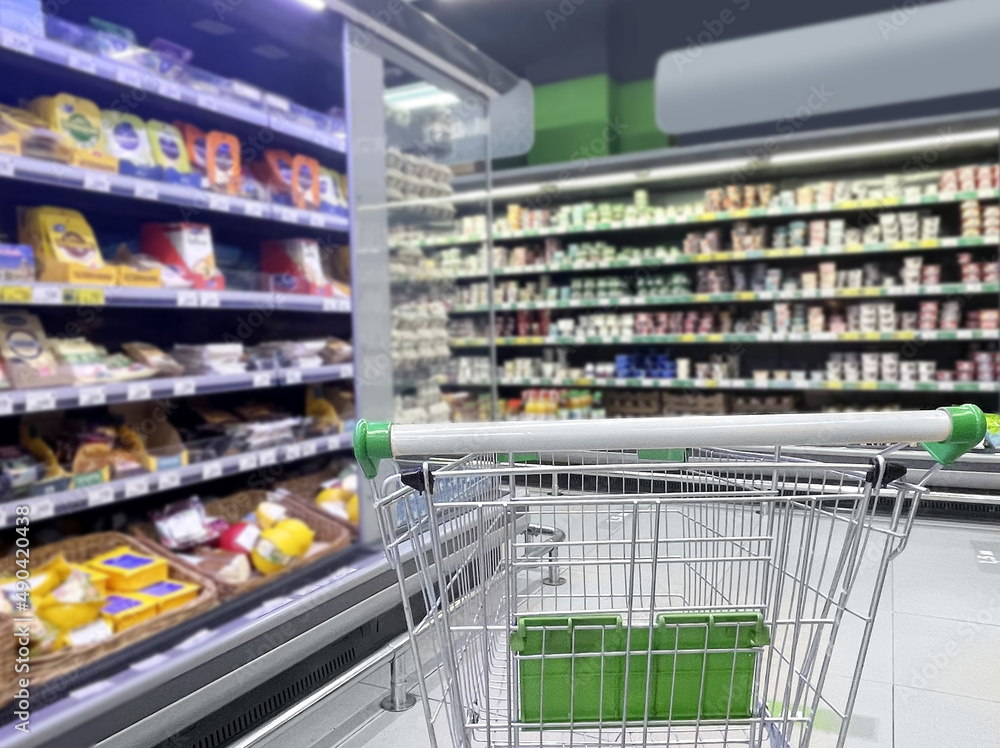 empty grocery cart in an empty supermarket empty grocery cart in an empty supermarket