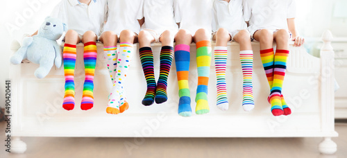 Kids with colorful socks. Children footwear. photo