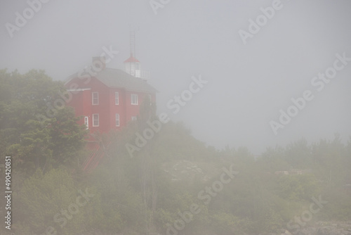 Marquette Harbor Light in the fog, lighthouse in Marquette, Michigan, USA