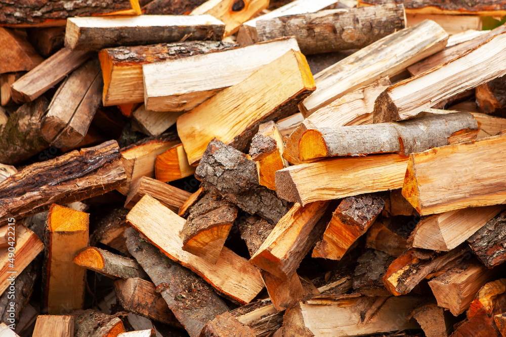 Background in the form of firewood chopped for heating the house, stacked randomly. Closeup. Background in the form of firewood chopped for heating the house, stacked randomly. Closeup.