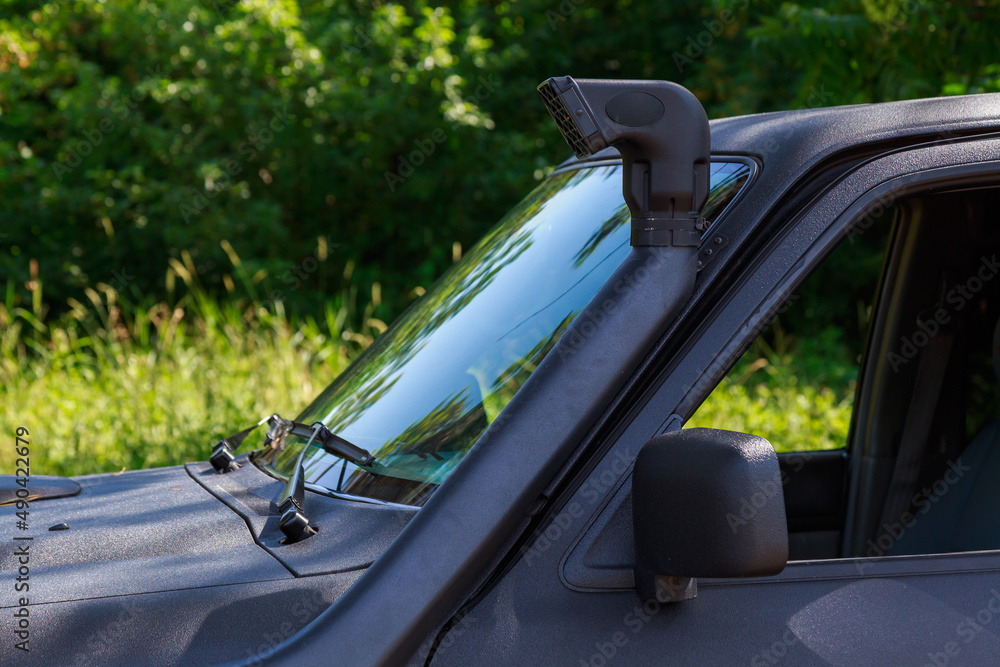 Snorkel or exhaust pipe of a 4x4 offroad vehicle. Background with copy space Stock Photo