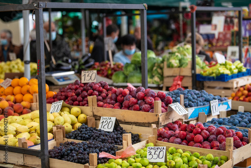 Open air street market (pijaca) with freshly harvested fruit in Belgrade, Serbia. Colorful food, healthy lifestyle. Plums, figs, grapes, pears, peaches and oranges.
