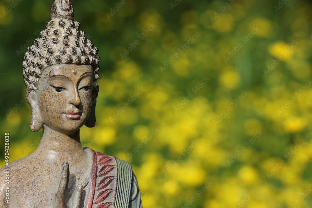 Buddha Statue With Field of Yellow Flowers in Background