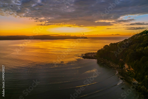 Aerial sunrise seascape with low clouds