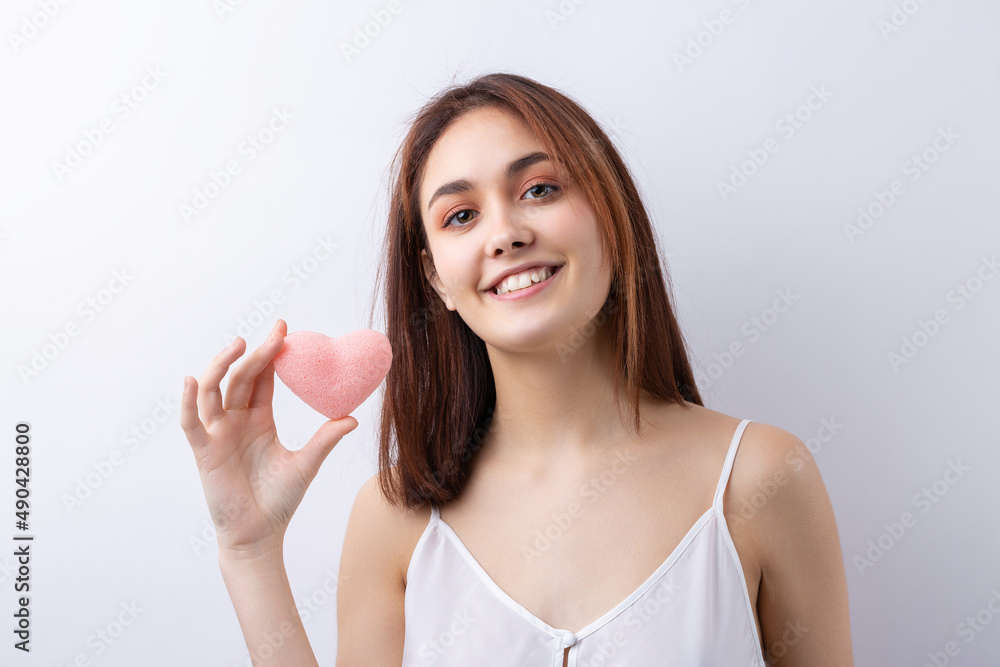 Beautiful smiling woman with clean skin, natural make-up and white teeth on a gray background Beautiful smiling woman with clean skin, natural make-up and white teeth on a gray background