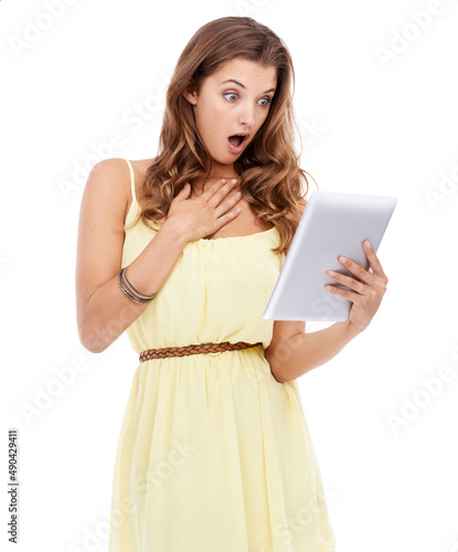 Youll be shocked at whats on the net. Studio shot of a surprised looking young woman holding a digital tablet.