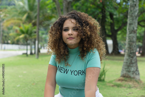 happy white curly haired teenager outdoors