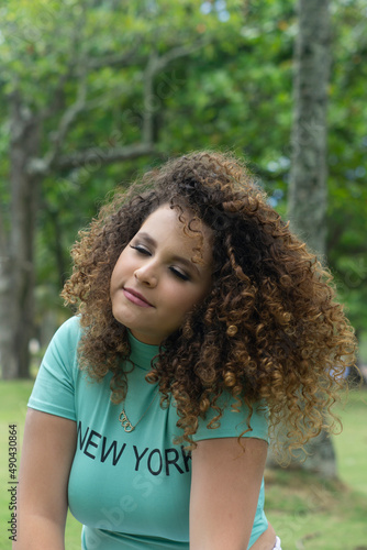 happy white curly haired teenager outdoors