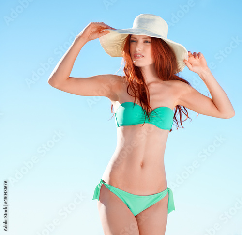 Summertime stunner. A gorgeous redhead posing in the summer sun in a bikini.