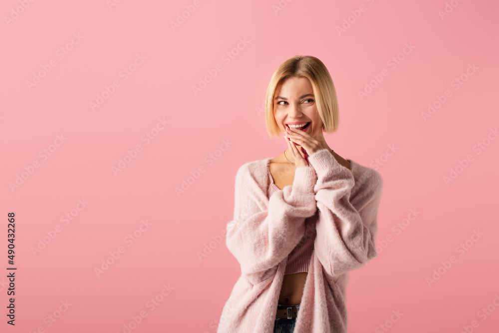 happy young woman in cardigan looking away isolated on pink. happy young woman in cardigan looking away isolated on pink.