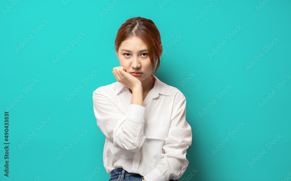 Gloomy young sad asian blond girl sighing upset stoop look from under forehead lonely unhappy lean palm bored feel regret sadness moody expression standing blue background pessimistic. Gloomy young sad asian blond girl sighing upset stoop look from under forehead lonely unhappy lean palm bored feel regret sadness moody expression standing blue background pessimistic.