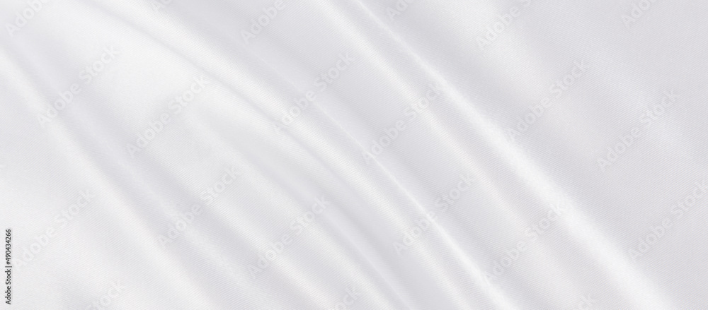Abstract white silk fabric texture background.  Creases of satin