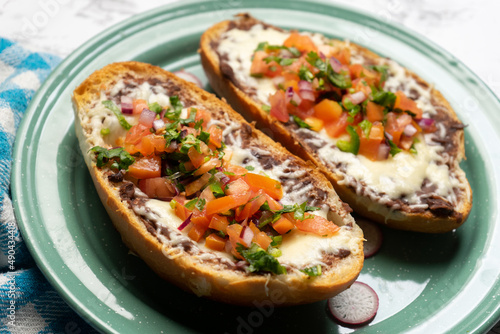 Molletes with fresh sauce and cheese. Mexican food
