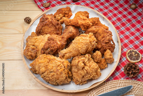 Fried chicken in wooden plate on wooden background, Deep fried Chicken on wooden table.