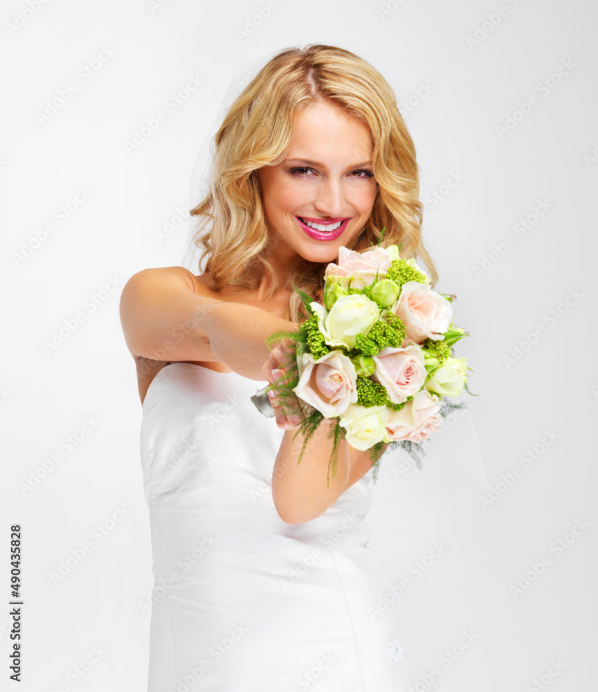 Its the perfect bouquet. Gorgeous young bride holding out her bouquet towards you - portrait.