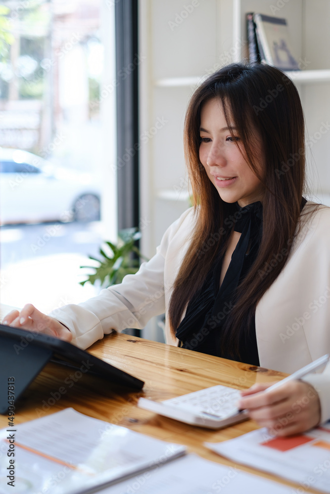 Asian accountant woman working audit budget and finance of company on wooden desk in office. consult, business, tax concept. Asian accountant woman working audit budget and finance of company on wooden desk in office. consult, business, tax concept.