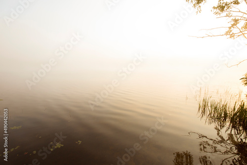 Warm summer sunrise and mist on Spectacle Pond in Vermont. photo