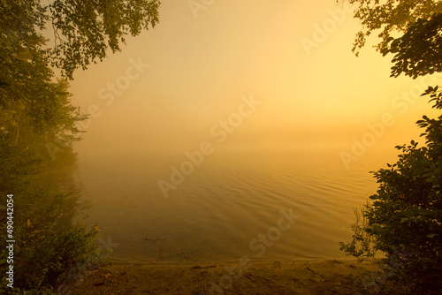 Warm summer sunrise and mist on Spectacle Pond in Vermont. photo