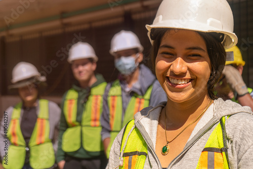 Empowered young woman, engineering student in front of a group of students and professionals