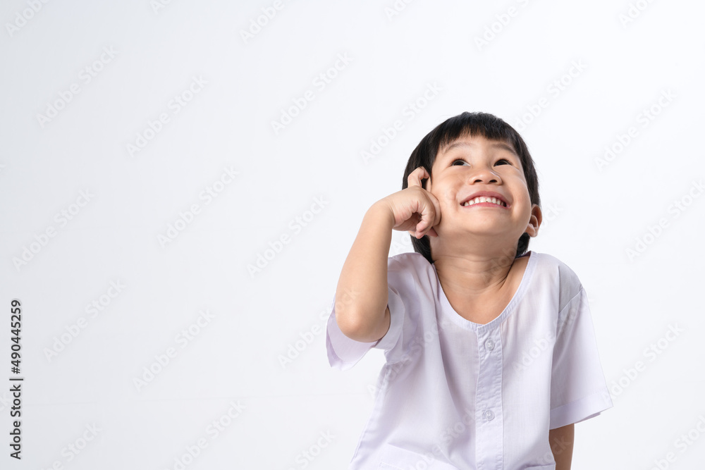 Asian boy in white dress with thinking expression Asian boy in white dress with thinking expression