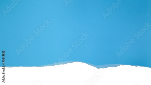 Torn blue paper on white background. Concept for presentation and education