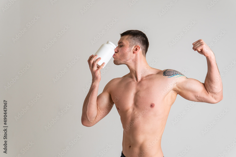 Fototapeta premium Fitness protein jars white on white background bodybuilder powder strong high body painful, backache sick male background medicine, illness Touching neck sickness, disease suffer attractive