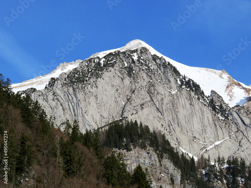 Snow-capped alpine rock Schofbergwand on the south side of the peak Wildhuser Schofberg in Alpstein mountain range and in Appenzell Alps massif, Wildhaus - Canton of St. Gallen, Switzerland (Schweiz) photo