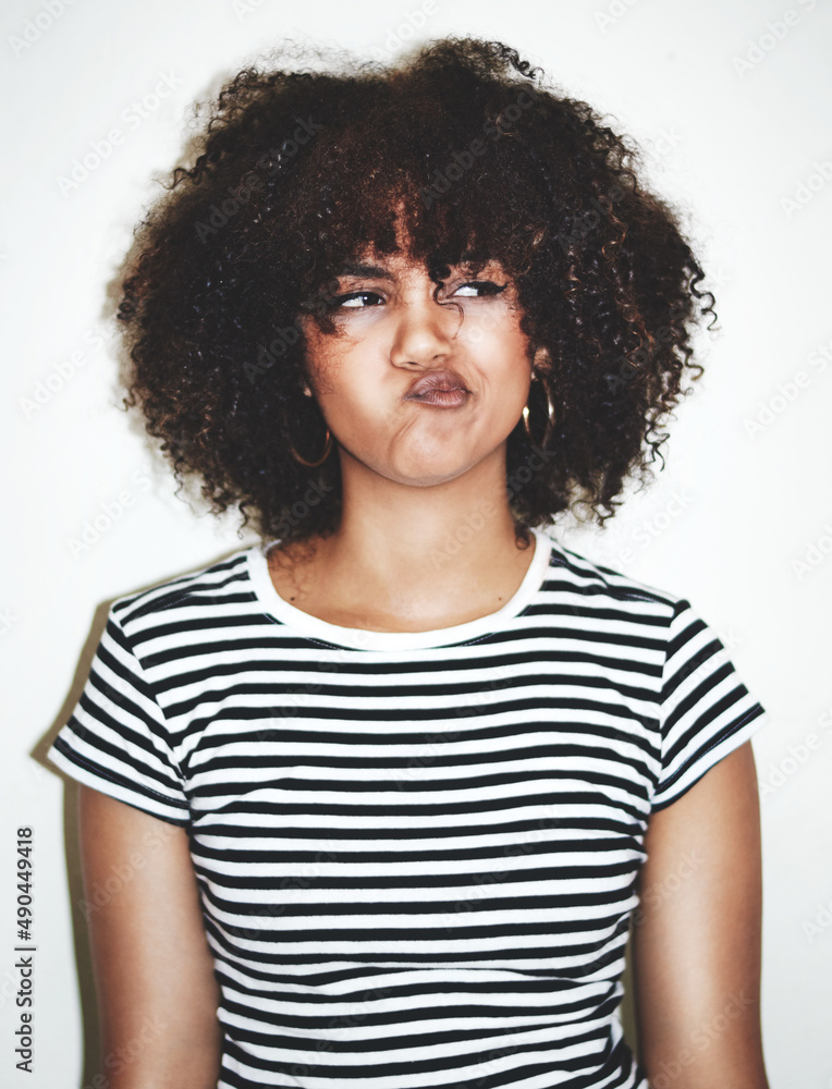 HmmI dont see that happening. Studio shot of a young woman pulling faces against a gray background. HmmI dont see that happening. Studio shot of a young woman pulling faces against a gray background.