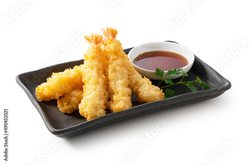 Shrimp tempura on a plate placed on a white background.