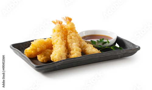 Shrimp tempura on a plate placed on a white background.