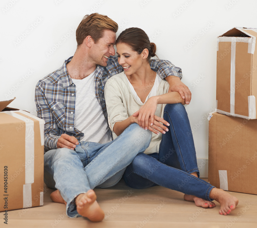 Settling into our new home. Shot of a young couple moving into a new home together. Settling into our new home. Shot of a young couple moving into a new home together.