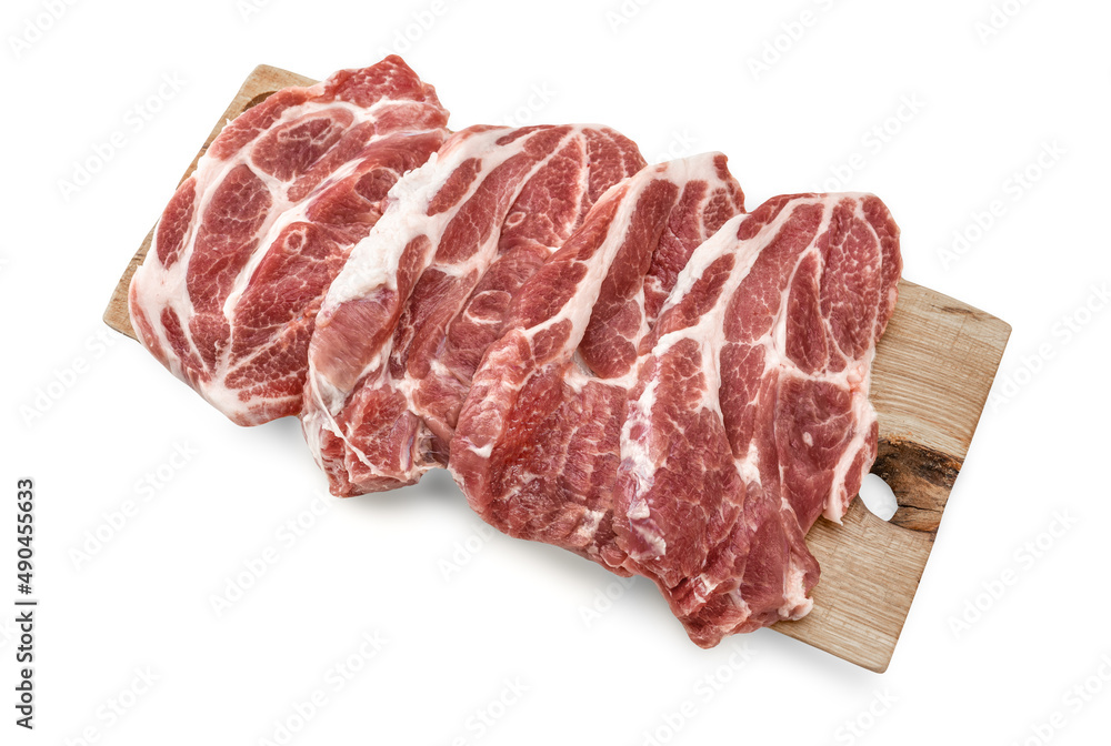 Fresh raw pork steaks on a cutting board isolated on white background. Top view. Pork neck raw meat for fresh steaks on wooden cutting board. Top view of heap of steaks on wooden cutting board